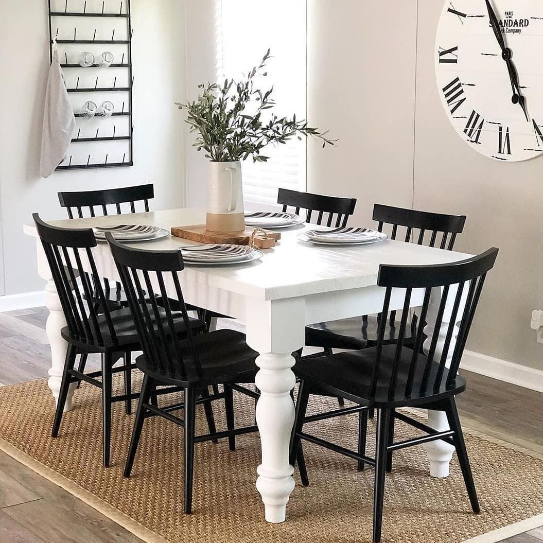 White farmhouse table with black deals chairs